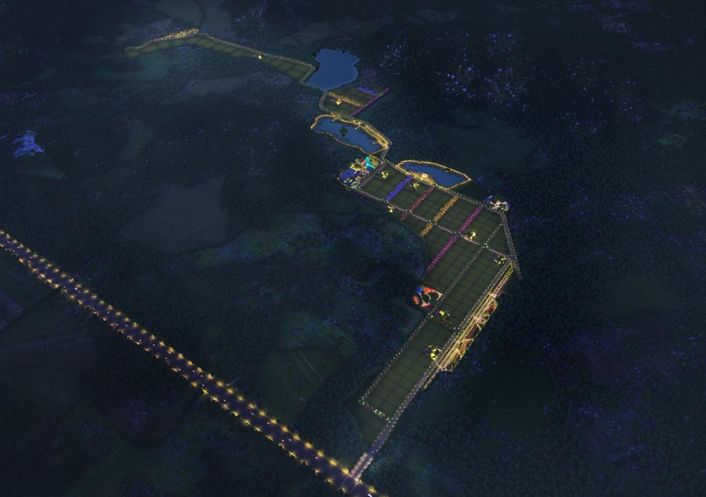Night aerial view of the Vrundha Valley layout with lit roads